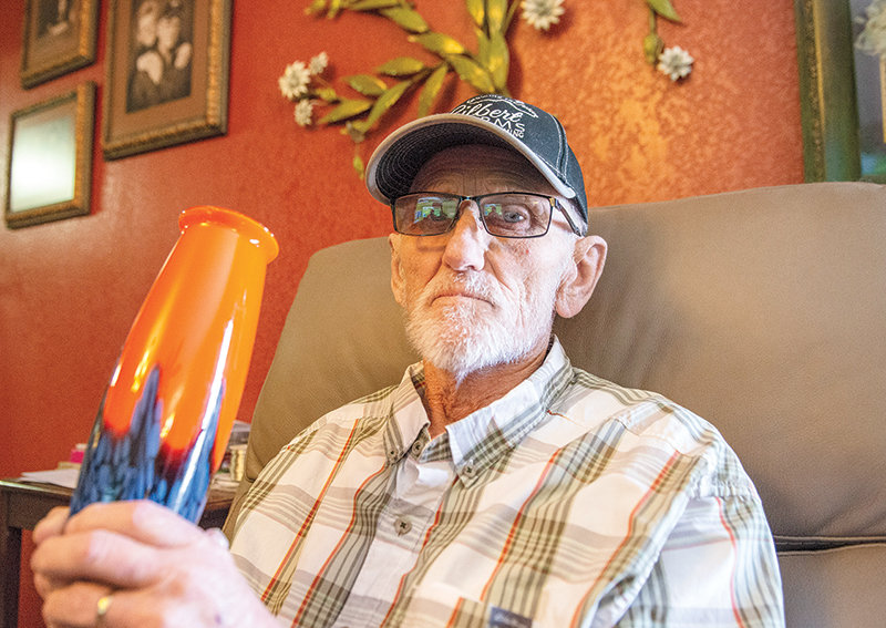 Dwight Gilbert shows his first piece of Czech art glass, the first in his massive collection of artwork. He originally bought the vase to hold a Denver Broncos flag, and later fell in love with blown glass.