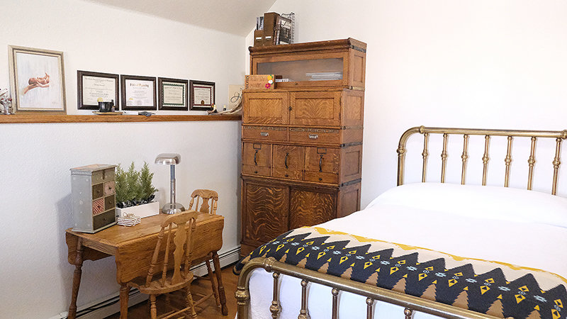 The birthing room in Melanie Lennon’s home is furnished with functional antiques including an old style metal bed frame.