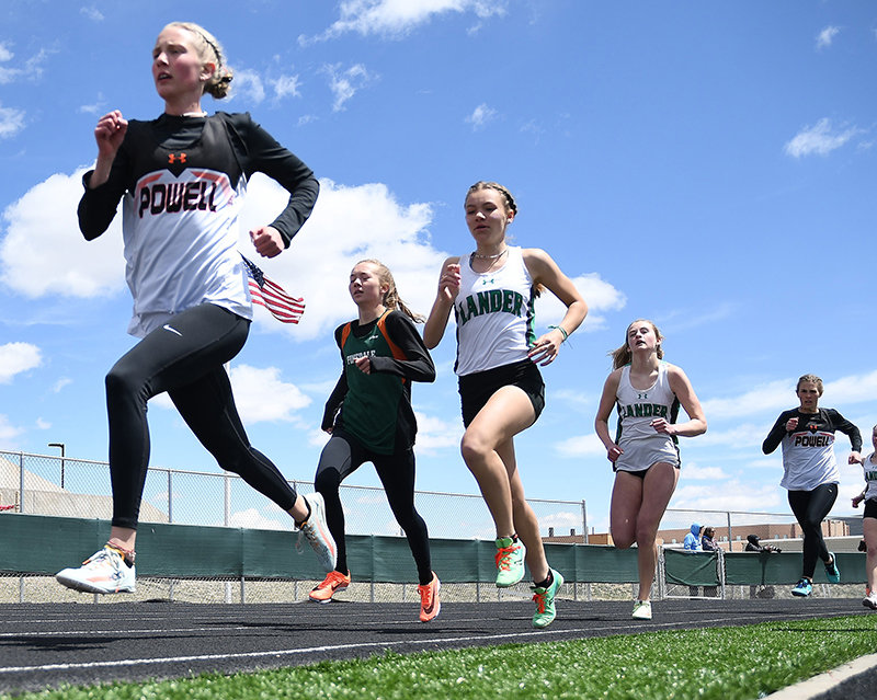 PHS freshman Kenna Jacobsen (left) and sister, junior Megan Jacobsen (right), fight to keep with the pace during the 800 meters. Both qualified for the state meet at the 3A West Regionals in Kemmerer, with state set to begin in Casper on Thursday.