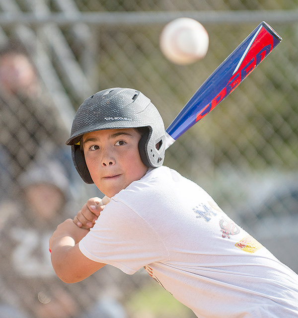 Ian Nelsen keeps his eye on the ball while participating in the Powell Little League home run derby Friday. The derby kicked off the season for the league’s 21 teams.
