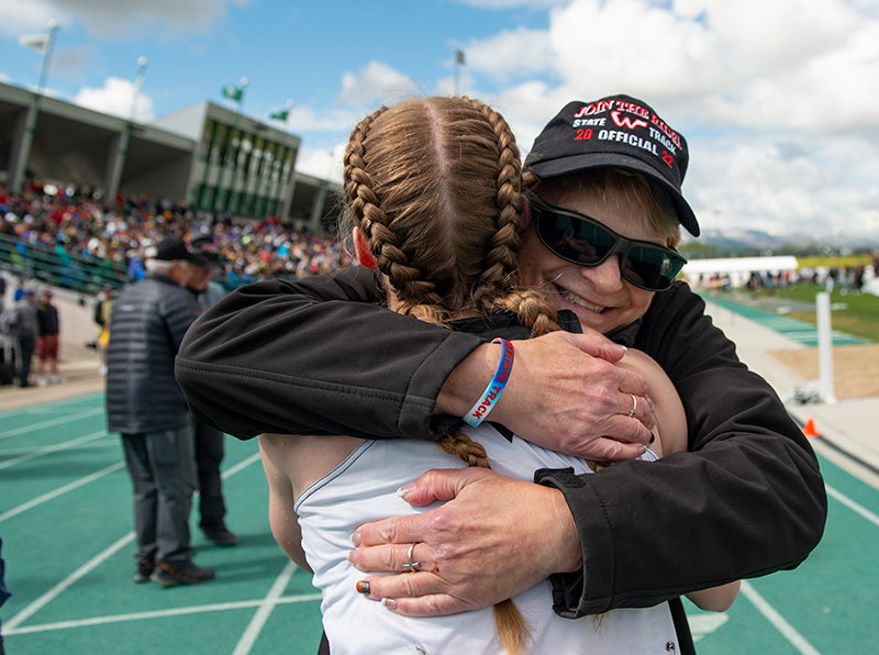 Panthers sprint coach Shelley Heny hugs senior Jenna Hillman after she won the 200 meter dash on Saturday in Casper. Hillman finished her career as a two time winner in the 200 meters and one time winner in the 100 meters.