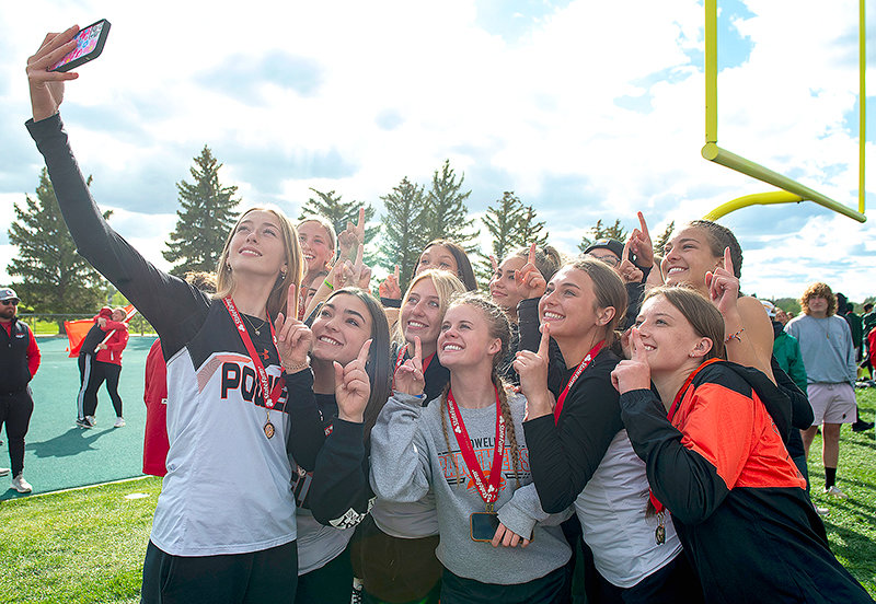 After finding out the team had won the state title, the Panther girls’ track team stopped for a minute to soak in the memory while waiting for the trophy presentation as sophomore Addy Thorington holds up her phone to take a selfie with the team.