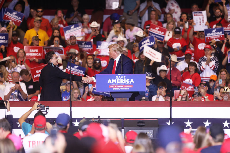 Former President Donald Trump shakes hands with Harriet Hageman, his pick to challenge Rep. Liz Cheney, during a rally Saturday at the Ford Wyoming Center in Casper. Trump implored his supporters to back Hageman while ripping into Cheney, perhaps his biggest Republican critic.