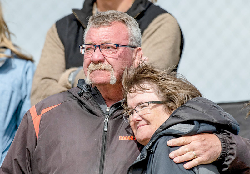 Nevin Jacobs embraces his wife Deb, as he looks on during the state track meet last month in Casper. Jacobs announced his retirement after 20 years as the throwing coach at PHS.