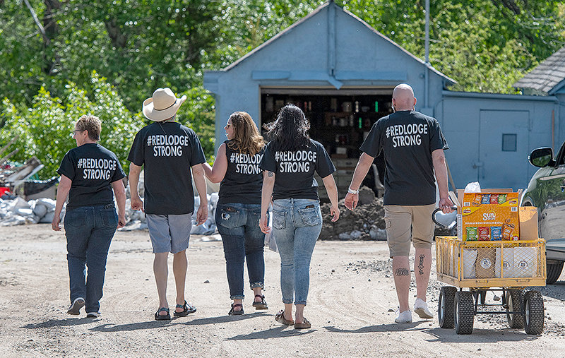 A group of volunteers wearing ‘Red Lodge Strong’ shirts and organized by Marni Echosbell, both a real estate agent and fire department volunteer in Red Lodge, canvas the area looking for folks in need of help in the form of sack lunches and muscle.