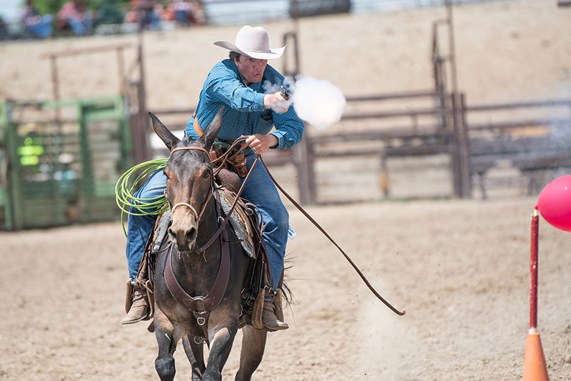 Clancy McNabb takes aim at the final balloon of his run during the mounted shooting section of the rodeo. McNabb’s run earned him a first place at the rodeo. The final round was narrowed down to the top four placers from competition earlier in the week.