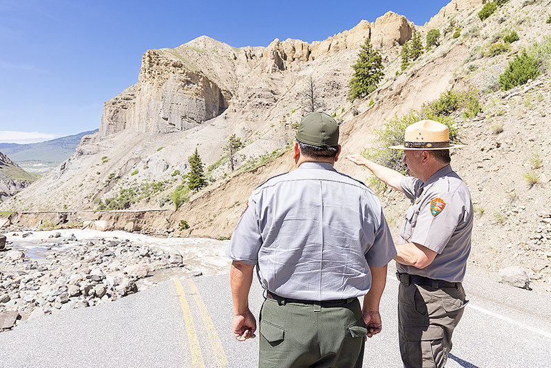 National Park Service Director Chuck Sams and Yellowstone National Park Supervisor Cam Sholly survey damage after floods ravaged the northern section of the park.