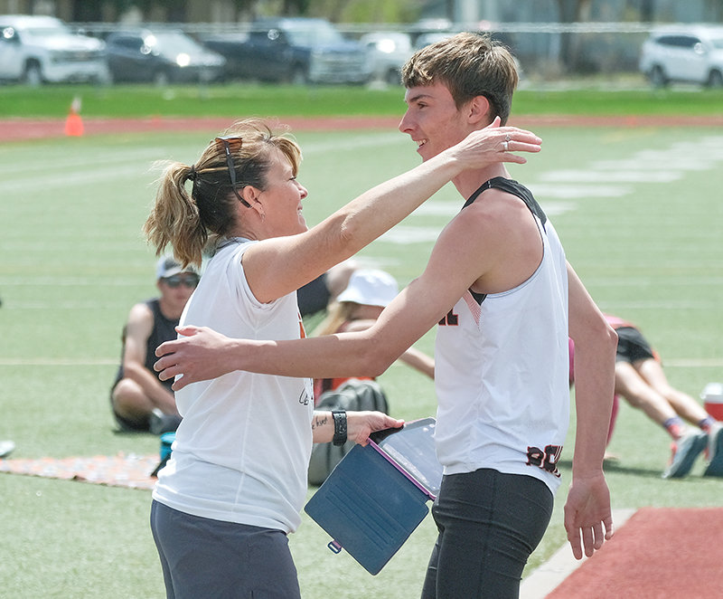 Taking in one of her favorite moments from the season, Panthers assistant coach Ashley Hildebrand goes to give Isaiah Woyak a hug after he cleared a personal best in the high jump at 6 feet, 6 inches.