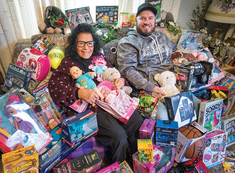 Sally Montoya and Nick Martin, a former area campaign coordinator for Toys for Tots, sat with toys destined to surprise children on Christmas morning in 2018.