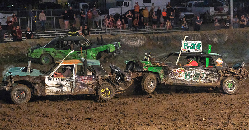 Trent Gillett (left) was the victor of the limited weld final, but was closely followed by Neil Moore (right) who attempts to rear-end him during the demolition derby on Saturday.