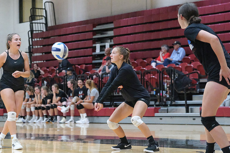 Sydney Spomer (left) and Saige Kidd (right) yell out while Alexa Richardson (middle) receives the ball during a match against Lovell in the NWC volleyball camp.