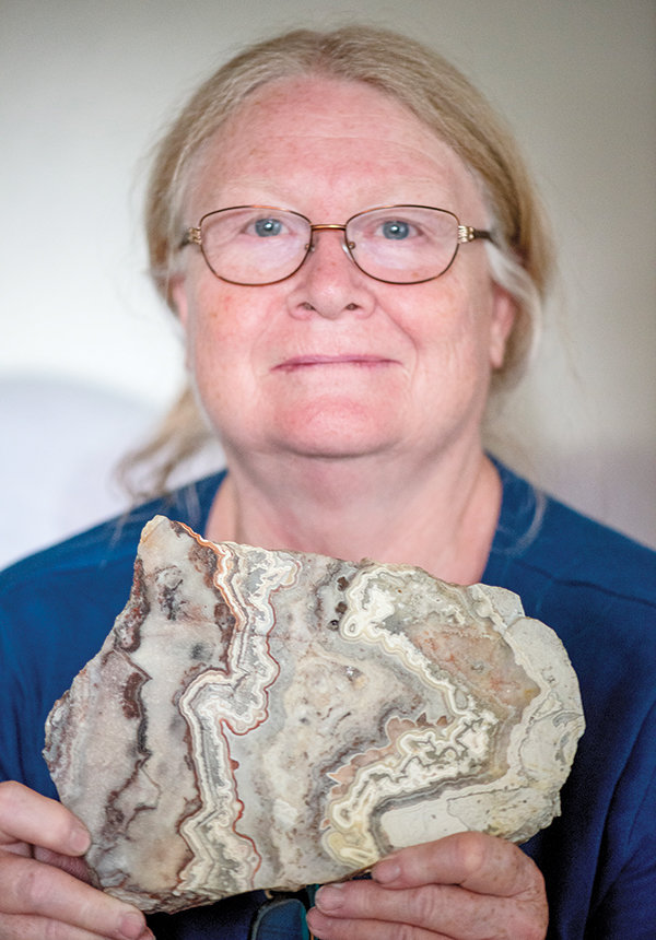 Cindy Cordova, chairperson of the Shoshone Rock Club’s show, shows a beautiful slab of agate cut with a rock saw — part of her collection.
