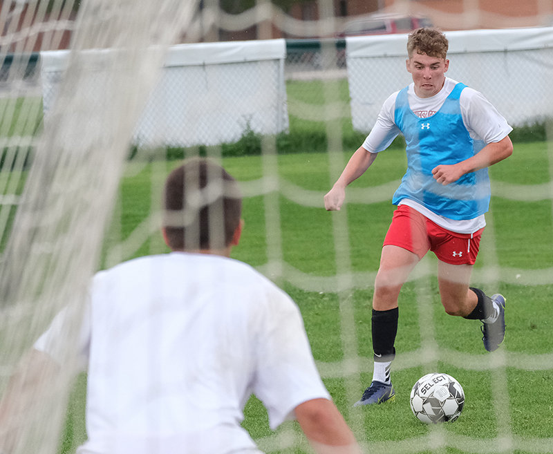 Ben Laybourne pushes the ball up the wing for the Trapper men’s soccer team during practice on Aug. 5. Twenty-six new freshmen highlight the NWC team in 2022.