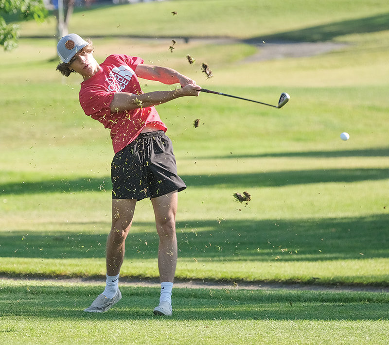 Grass flies around Panther senior Harrison Paul after a tee shot as the Panther golf team hit the course on Tuesday.