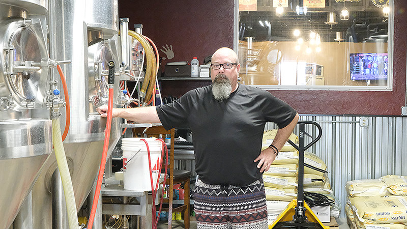 Steven Samuelson, head brewer at WYOld West stands next to one of several fermenters at the brewery.