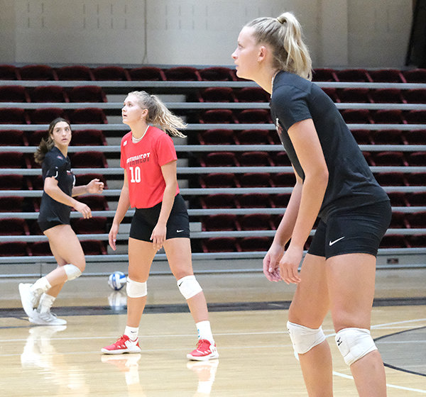 Megan Pannell (red) and Kim Pannell (right) anticipate a ball during practice on Aug. 9. The Pannell sisters made their way to Powell and will compete together for the Trappers this fall.