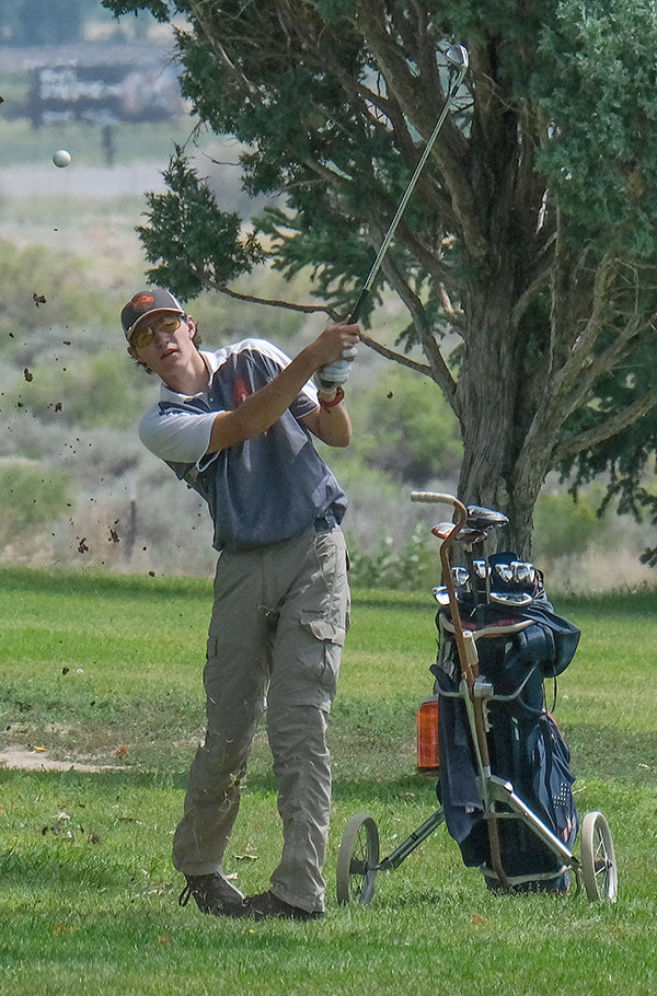 PHS junior Trey Peterson eyes his approach shot during the Panther’s home tournament on Thursday.