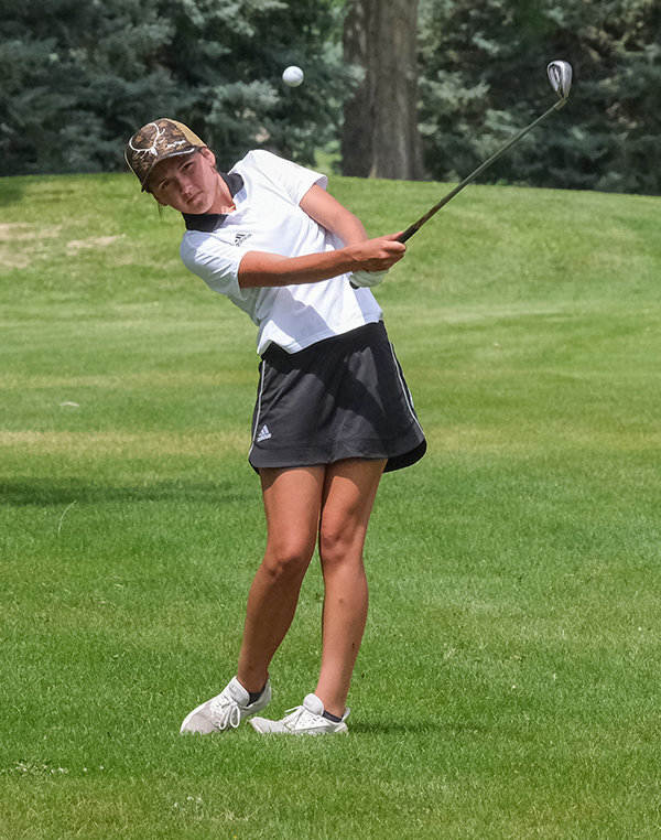 Freshman Coy Erickson lays up an approach during her first ever competition for the Powell Panthers golf team on Thursday.
