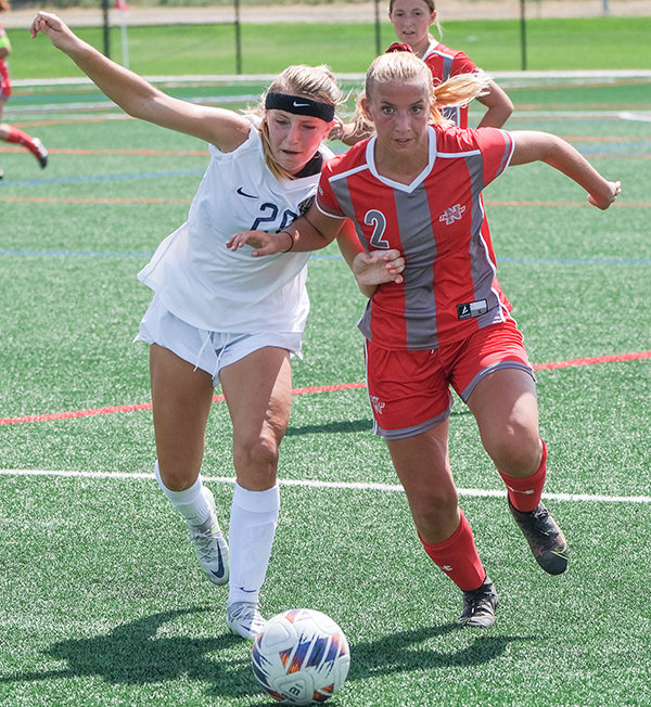 Sophomore Zoey Bonner (right) fights for positioning against a Montana State University Billings midfielder as the Trappers finished up their third game in four days.