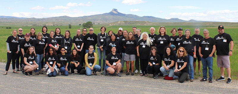 Group one from the 2022 educator workshops pose together in front of Heart Mountain.