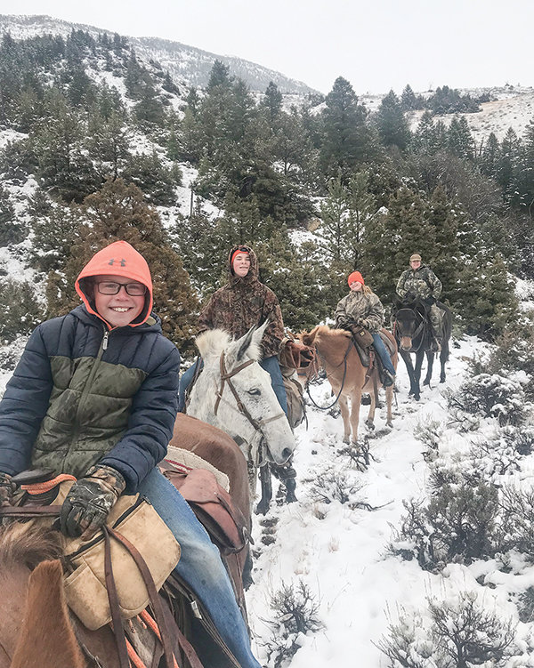 Tucker, Curtis, Charlee and Christy Muecke head into the forest during hunting season while following dad and husband, Ryan Muecke. Ryan has harvested at least one of every species of big game in the state except a mountain goat.