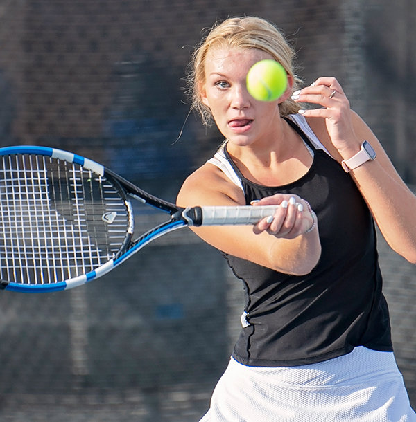 Sydney Hull returns a shot during the No. 1 doubles match on Friday. The Panther tennis teams head to state this weekend in Gillette.