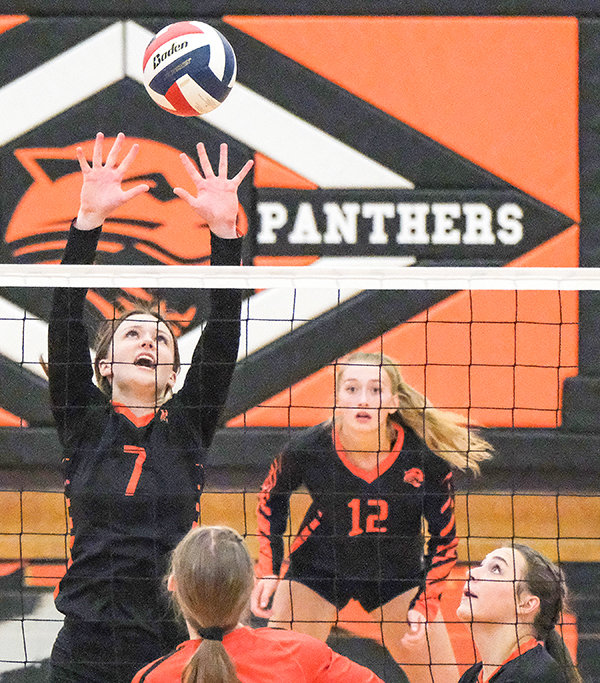 Waycee Harvey reaches high, trying to get a block against Worland on Saturday in the Panthers’ home opener.
