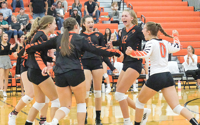 The Panther volleyball team celebrates after winning the second set against Worland on Saturday. Powell defeated the Warriors in conference play for the first time since 2018.
