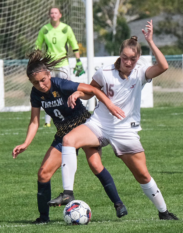 Katelynn Campbell battles in the midfield with a Trinidad player on Friday. The Trappers head out on the road for Region IX play this weekend.