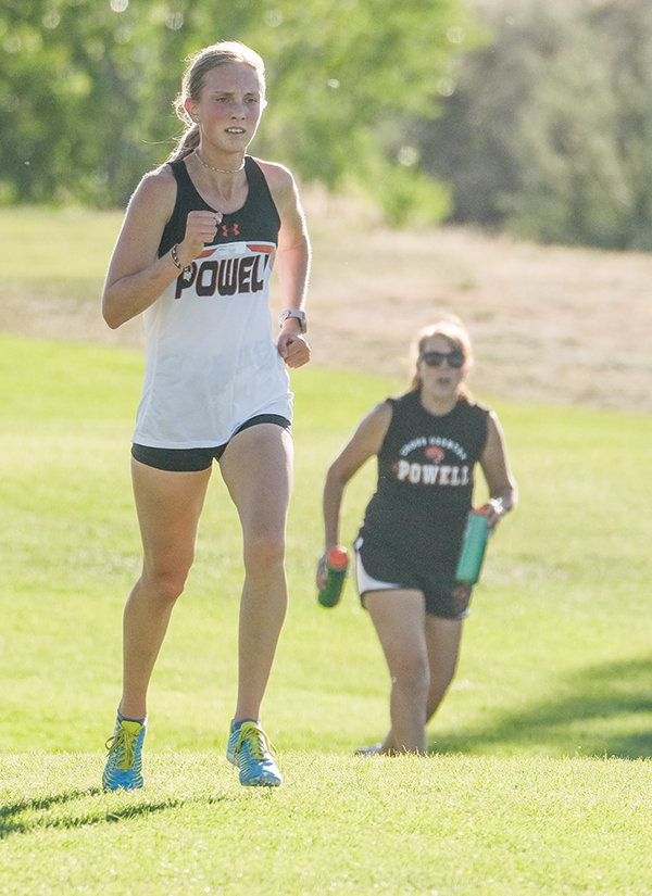 Kenna Jacobsen ups the pace toward the finish line while coach Ashley Hildebrand helps push her to a strong time.