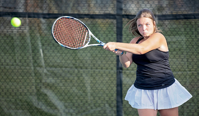 Alli Harp returns a shot during the North Regional Tennis Championships in Cody. Harp and partner Sydney Hull advanced to the consolation semifinals at No. 1 doubles at the state championships last weekend.