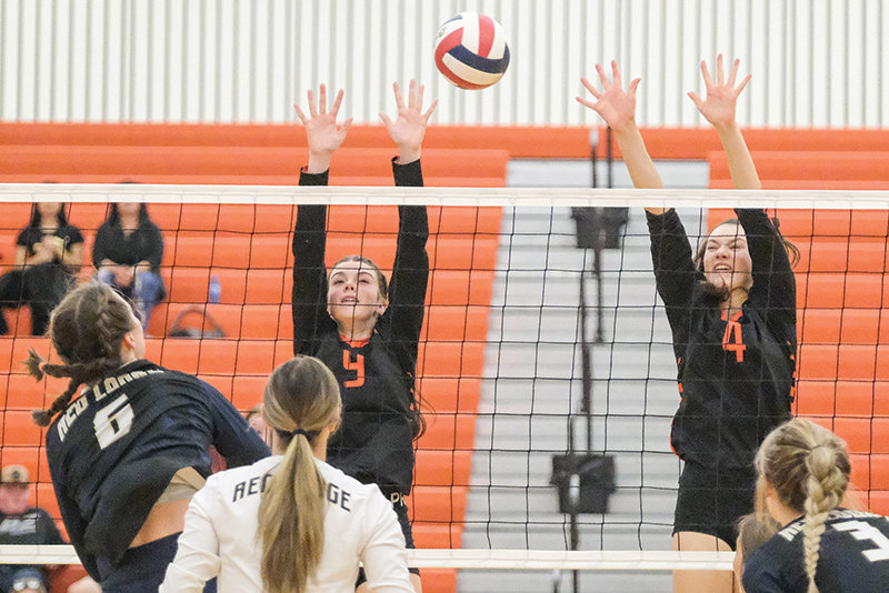 Gracie Trotter (left) and Saige Kidd go up for a block in the second set against Red Lodge on Tuesday.
