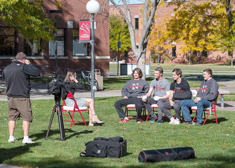 (Left to right) Trapper wrestlers August Harrison, Kendell Cummings, Brady Lowry and Orrin Jackson are interviewed by Billings broadcaster Hailey Monaco on campus Wednesday. The group has entertained offers to also appear on national broadcasts, including Tucker Carlson and Jimmy Kimmel.