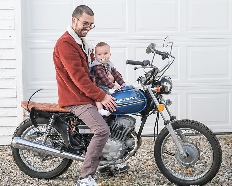 Braden Schiller (left) sits with his son Atticus James on 
a nearly completed 1978 Honda Twinstar. Braden began the project shortly before his son was born.