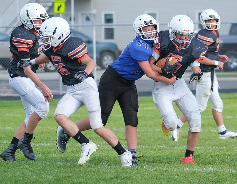 Eighth grader Broc Frank fights through a Lovell tackler during the Cubs game in October. The eighth grade team finished second in the conference with a 4-1 record.