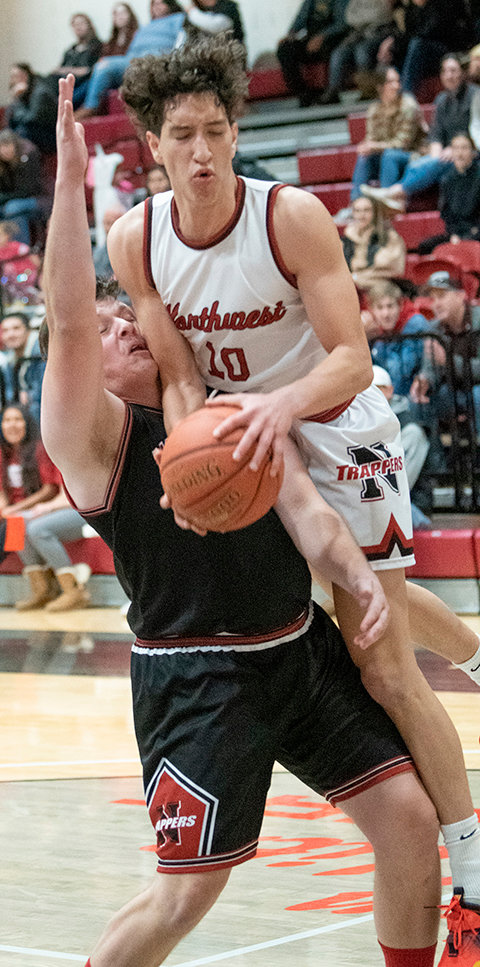 David Ayala finishes hard at the rim against former PHS and Northwest College standout Carter Baxter on Friday. Northwest heads on the road for a three week period, starting with the Miles Community College Classic on Friday and Saturday.