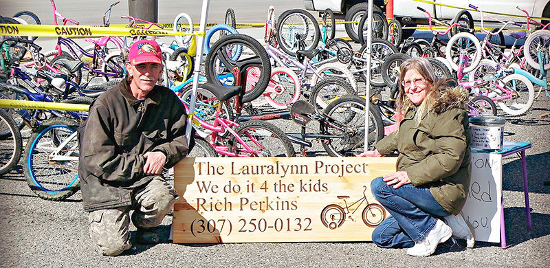 Richard and Sherrie Jean Perkins pose with their traveling bicycle donation wagon, known as the Lauralynn Project, while on a stop in Powell recently. Sherrie Jean is fighting cancer and the couple halted the project.