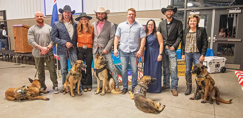 A group of veterans and first responders aided by service dogs stand with Wes and wife Kaycie Mangus at the K9 Elite banquet held Nov. 11 at the Park County Fairgrounds. Pictured (from left), Sean Holloway, Jerrid and Tara Geving, Colan Kellogg, Lance Patenode, Kaycie and Wes Magnus and Jody Tennis.
