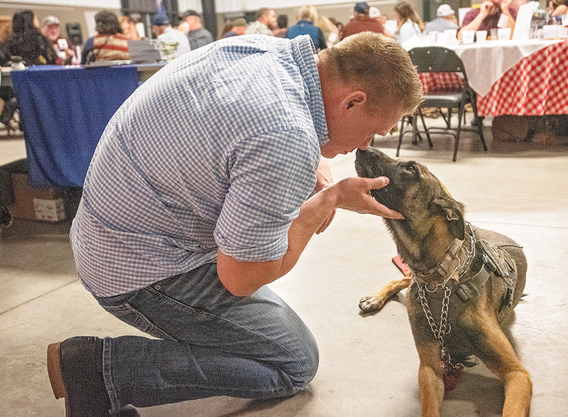 Lance Patenode shares a moment with his service dog Thor.