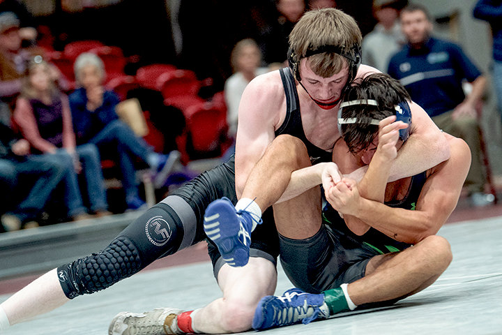 Avery McSpadden holds down his opponent during the Joe Mickelson Memorial Wrestling Open in November. The Trappers head on the road for a top-10 showdown on Friday in Rock Springs.