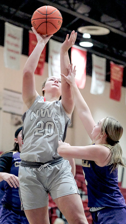 Natalyah Nead rises up over a Carroll College defender during a home contest in November. The Trappers head out on the road one more time before coming home next Thursday and Friday.