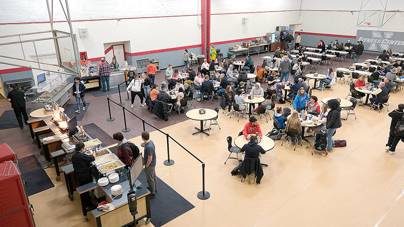 Students fill the tables last Wednesday for the first day of the new semester in the Johnson Fitness Center, which has become the temporary dining facility until the new building is finished. The building near the soccer fields will serve as a dining hall until the student center is finished.