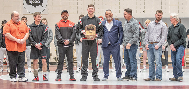 The Apodaca Award is presented to Ryker Blackburn, flanked by former Trapper coaches and award winners during the Apodaca Duals on Friday night. From left: George Laughlin, Brady Lowry, Art Costello, Blackburn, Jim Zeigler, Travis Carter, Bobby Robins and Steve Knopp.