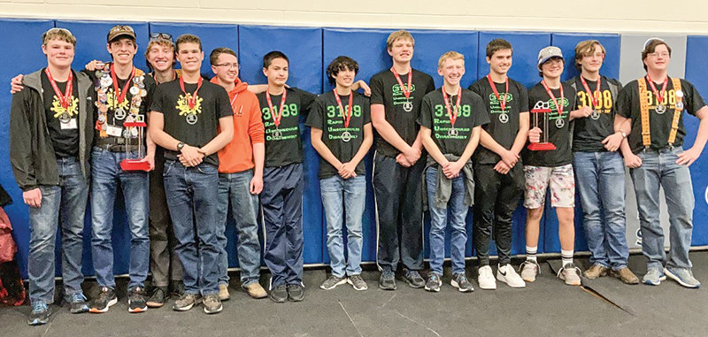 Powell High School robotics teams Squiggle Splat Bang and Rapid Unscheduled Disassembly stand together following the state competition in Casper. From left, Isaac Stensing, Daniel Merritt, Kalin Hicswa, David Polson, Luke Legler, Elias Brower, Mason Coombs, Dallin Waite, Brighton Streeter, Alan Crawford, Dexter Opps, Keenan Lind and Jacob Harms pose together following Rapid Unscheduled Disassembly’s first place win.