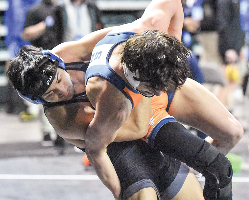 Bobur Berdiyorov (left) battled to a fifth place finish at 141 pounds, capping off a strong second stint with the Trappers.