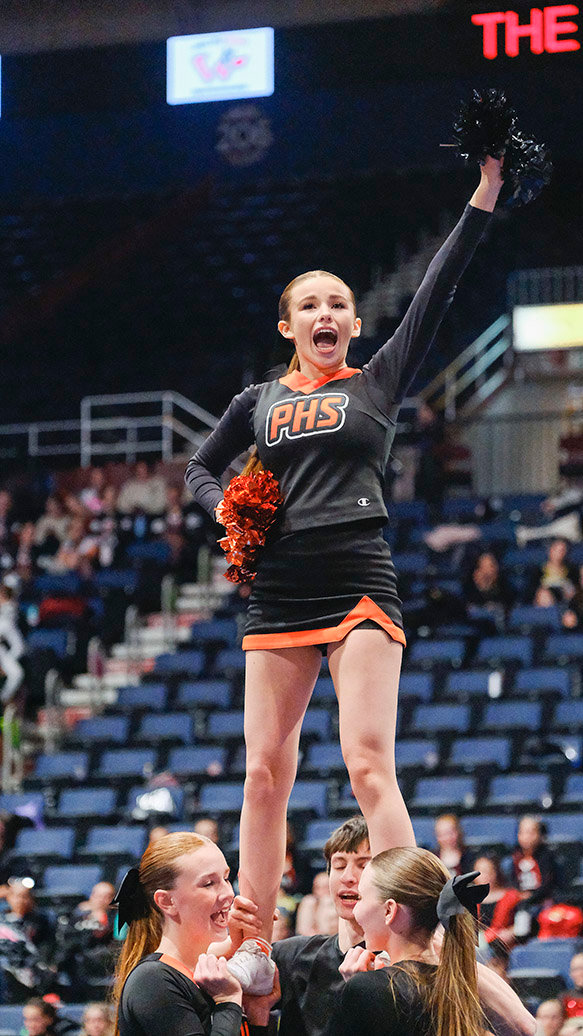 Kora Terry stands atop the base during the state cheer routine for the Powell Panthers. Powell improved to a fourth place finish this season after placing ninth last year.