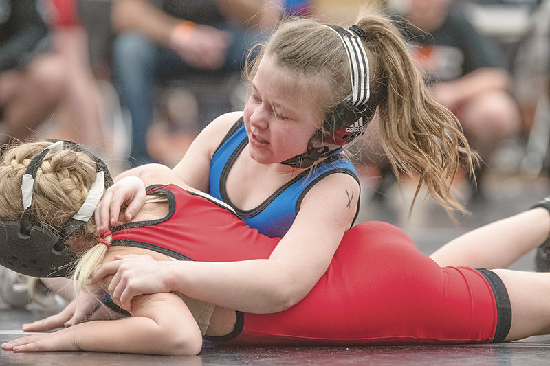 Powell’s Bristol Pettet holds down Greybull’s Clancy Thacker during the Powell 3-Style Tournament on March 10.