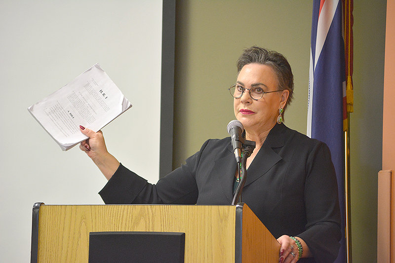U.S. Rep. Harriet Hageman (R-Wyo.) holds up H.R. 1 — the Lower Energy Costs Act brought by the Republican Party — during a Friday town hall at the Cody library. Hageman covered a host of subjects before a packed house of attendees.