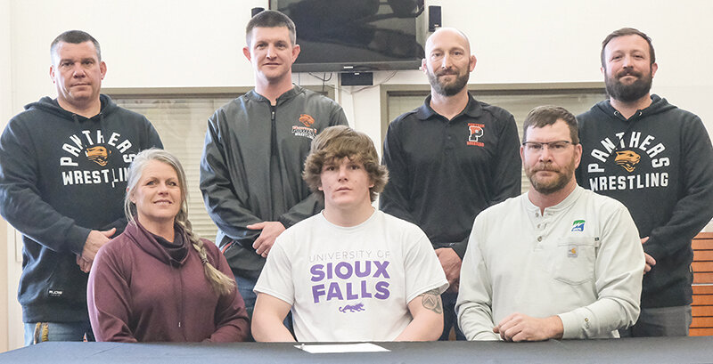 Stetson Davis was surrounded by his coaches and parents while signing to continue his wrestling career on Tuesday. Back row from left: Nate Urbach, Nick Fulton, Juston Carter and Cody Kalberer. Front row from left: Candice, Stetson and Paul Davis.