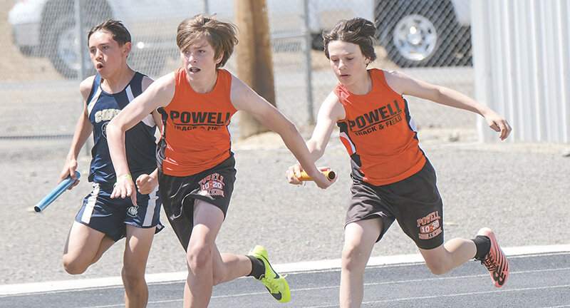Braxton Nelson (left) and Brayden Benander hand off during the 4x100 on Saturday in Lovell. The seventh grade boys ran away with the team competition by 90 points.
